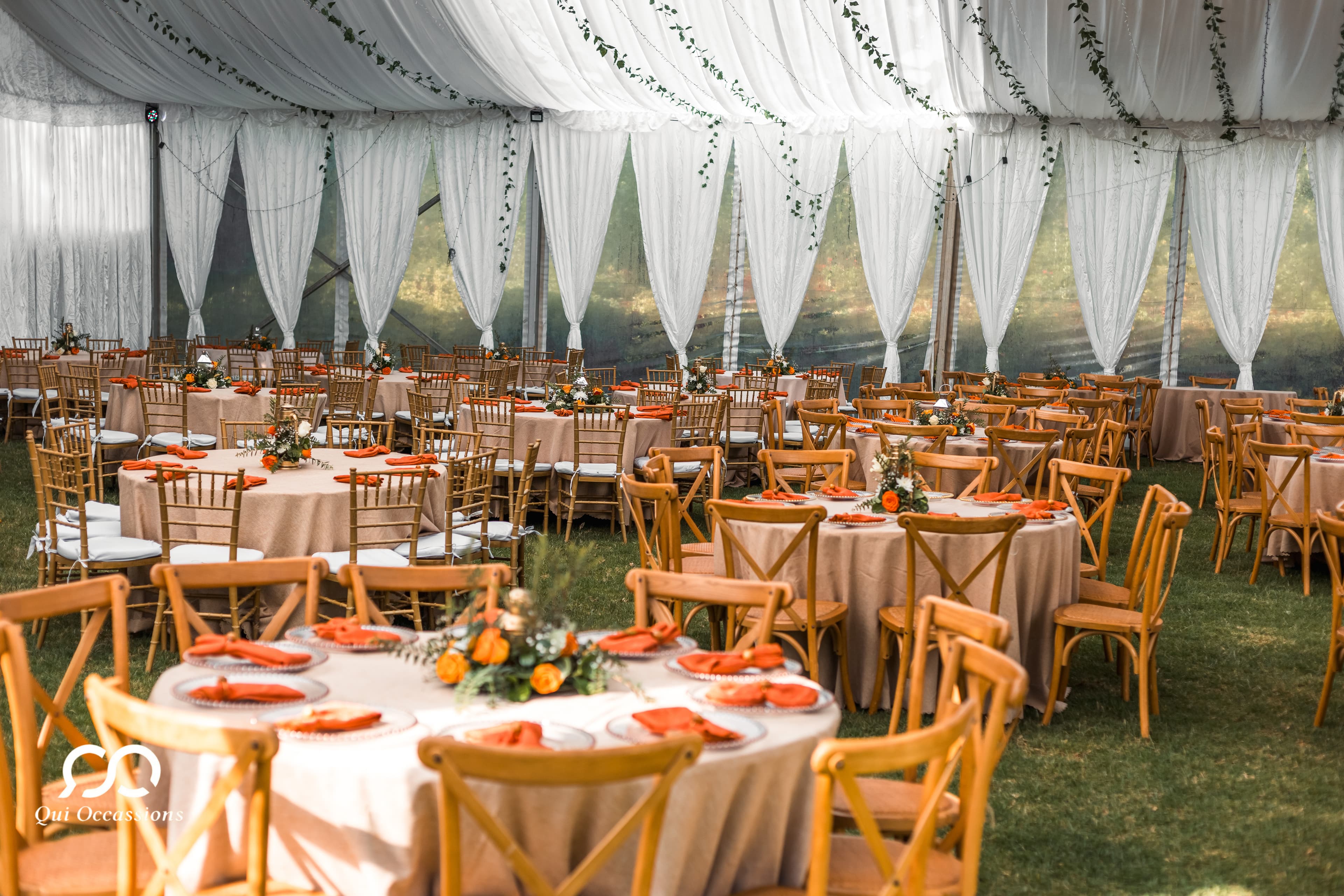 Elegant outdoor wedding reception with white tent and floral decorations